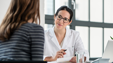 A woman and a doctor talking in an office