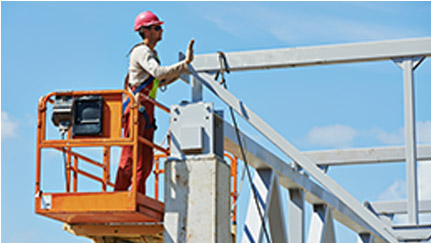 Man in a crane fixing a building on a construction site