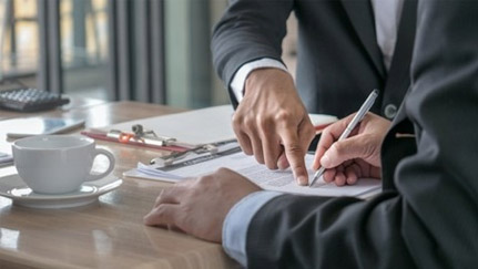 person signing a document