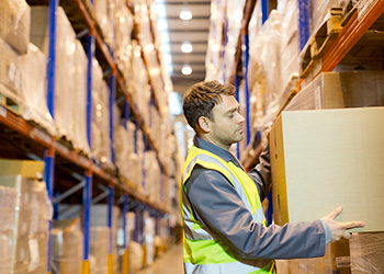 Man holding a box in a warehouse