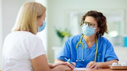 medical worker and woman wearing face masks