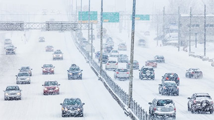 vehicles driving on a snow-covered highway