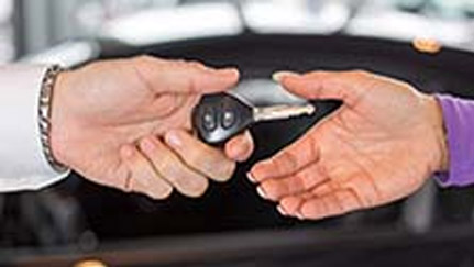two hands exchanging car keys