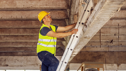 Acrobat balancing upside down on a ladder stock photo