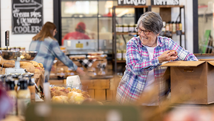 Woman unpacking a box in a store